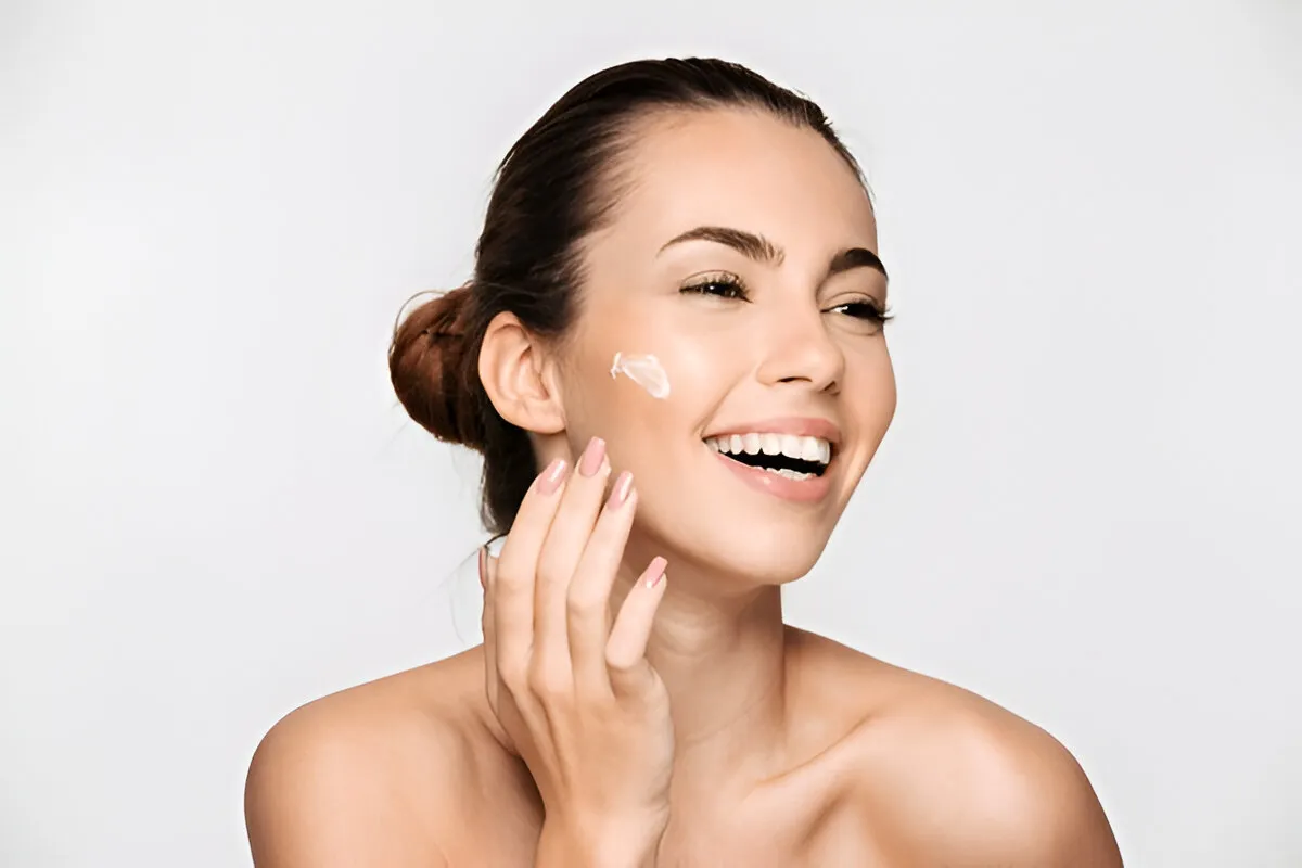 Woman applying skincare cream